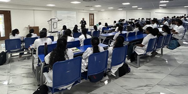 Long shot: Dr. Joshi speaking to students sitting in the college hall
